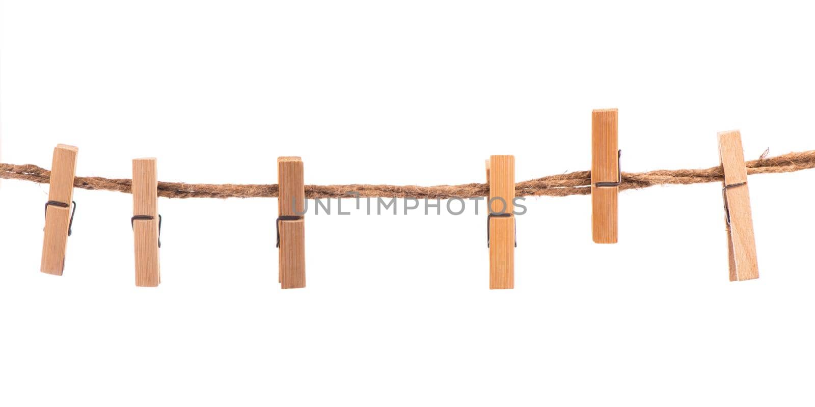 Clothespins with the rope on a white background by aprilphoto