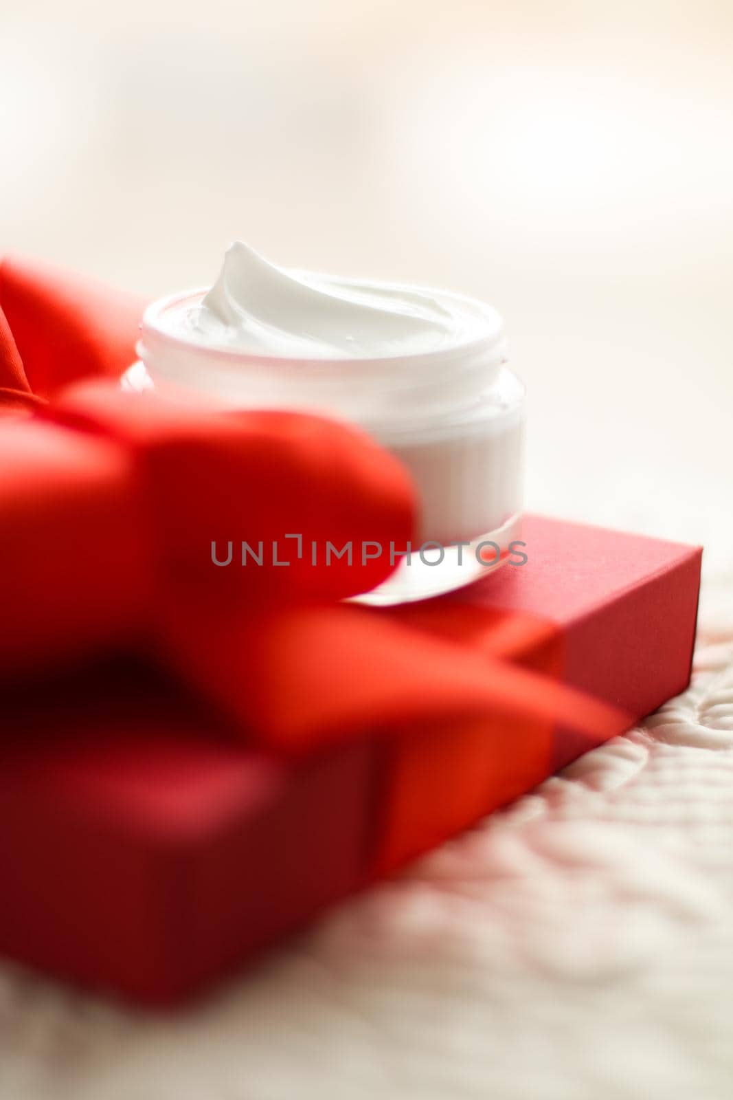 Beauty, cosmetics and skincare styled concept - Luxury face cream jar and red gift box