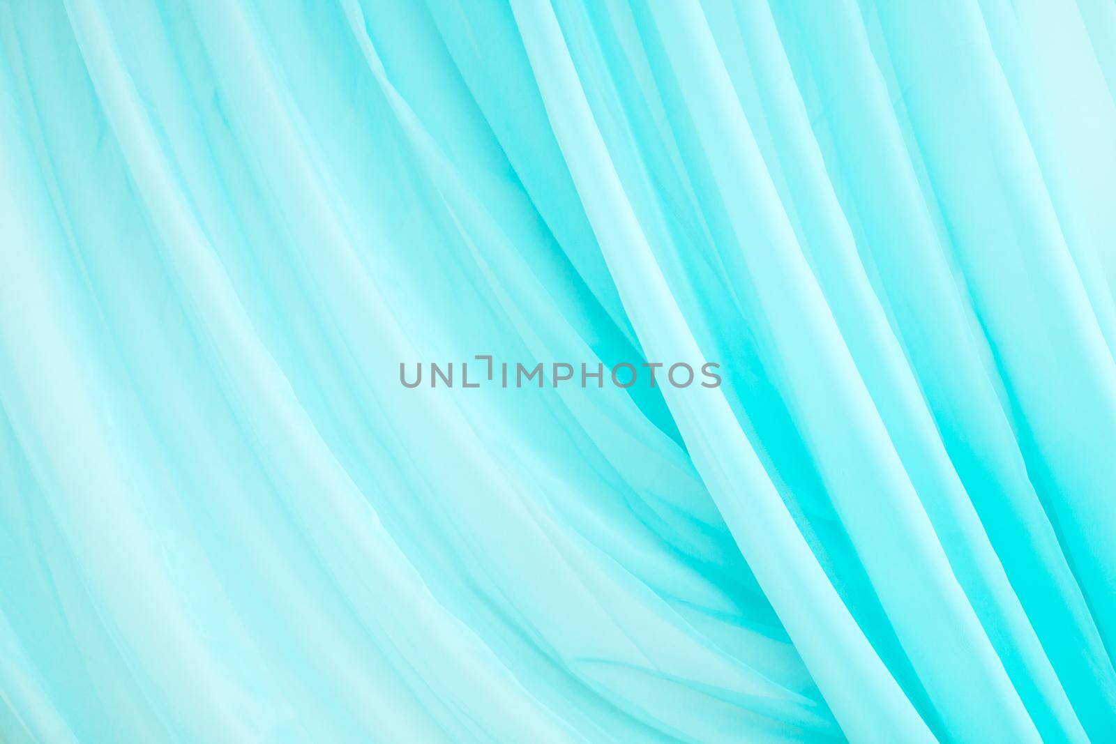 The texture of turquoise fabric . Light curtain. Lightweight fabric. Copy space .