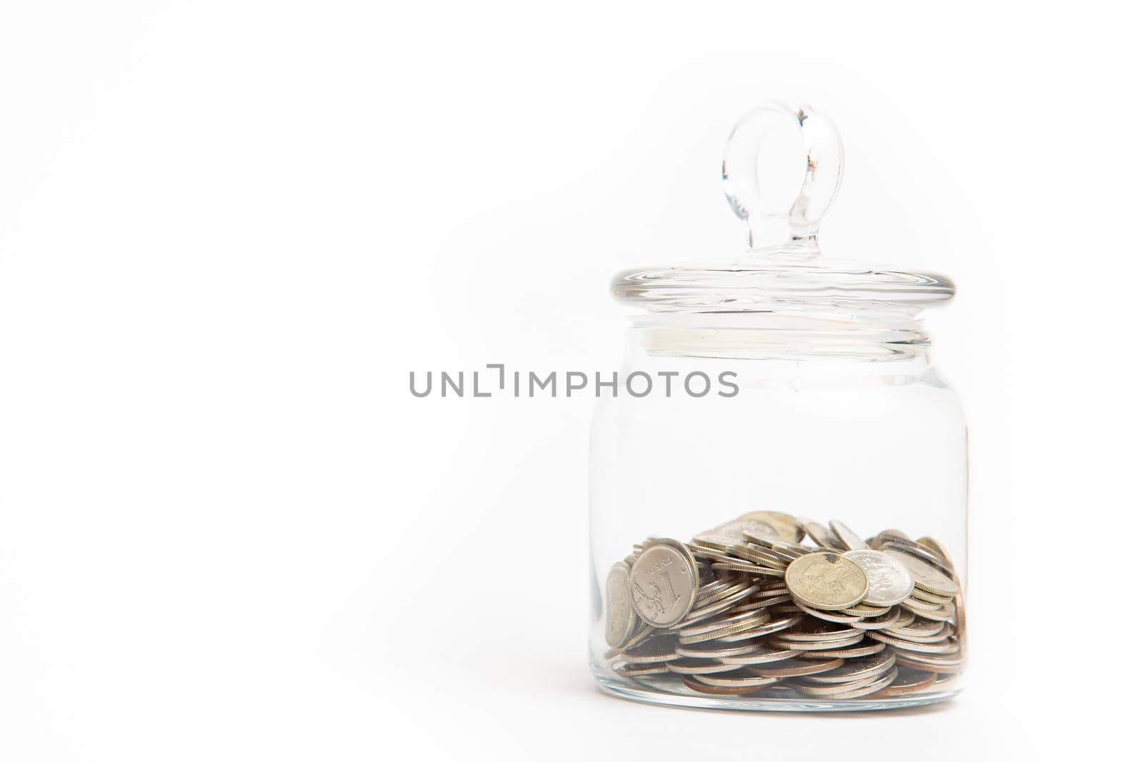 The coins in the bank are isolated on a white background . Business and finance. Lots of coins. Copy space. Investment