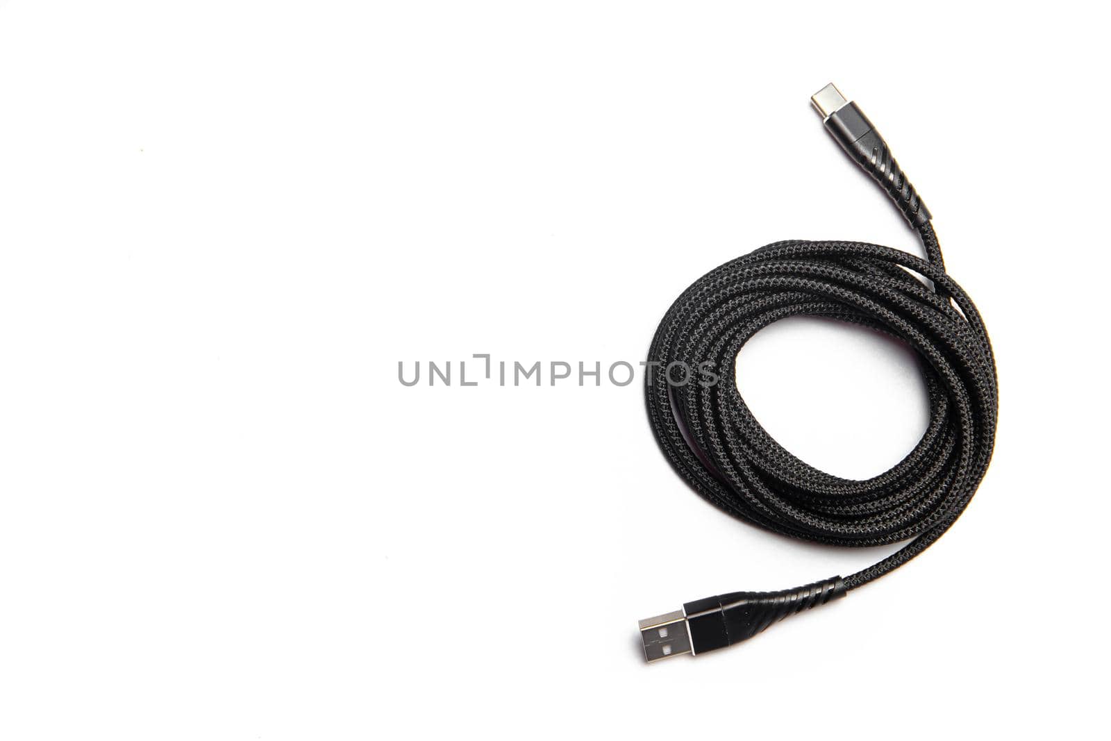 Black wire isolated on a white background. Twisted wire. White background. Copy space