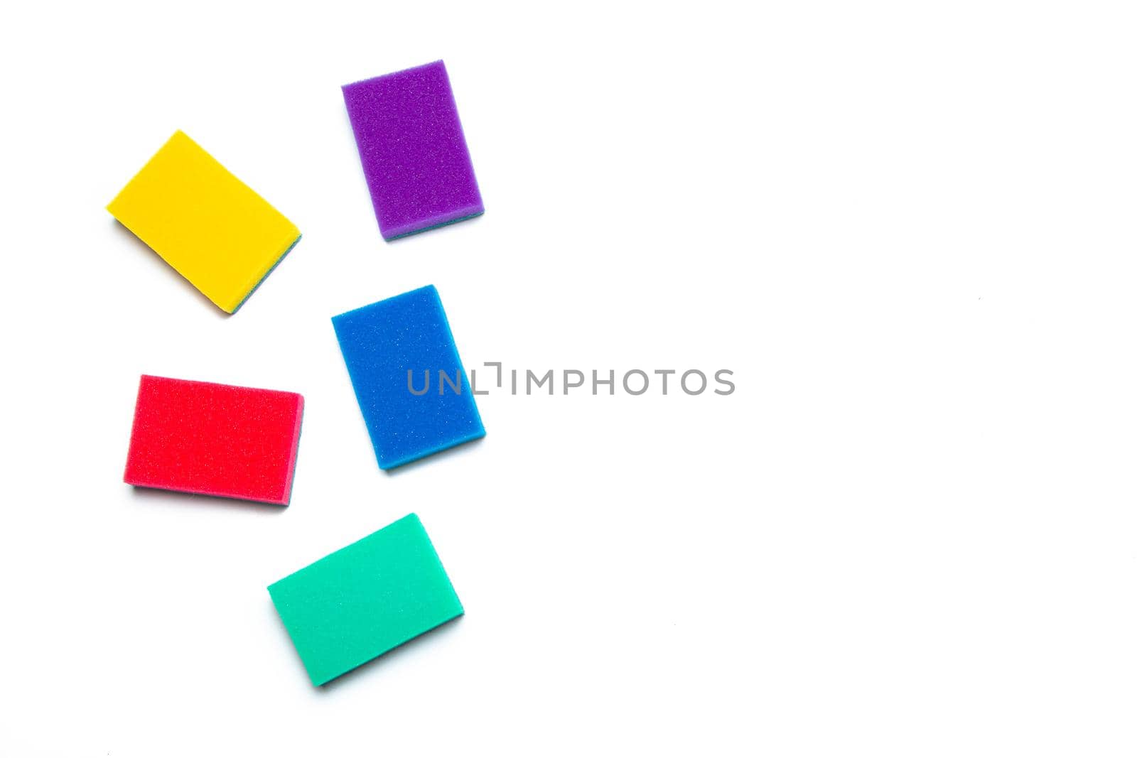 Sponge for washing dishes on a white background . Household items. Clean dishes. Help in the kitchen. Colored sponges. Isolated background. Copy space.