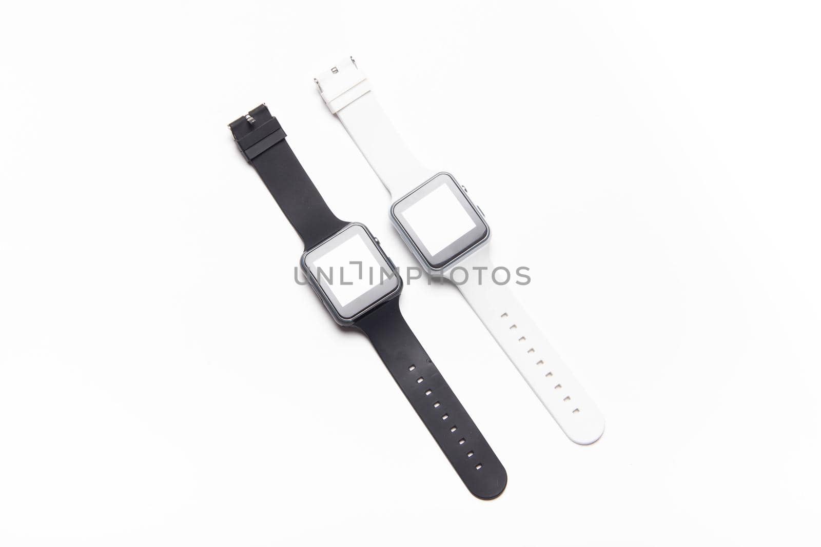 Electronic wrist watch on a white background . White and black wrist watches. Women's and men's watches. Isolated background. Article about modern watches. Article about choosing a watch. Copy space