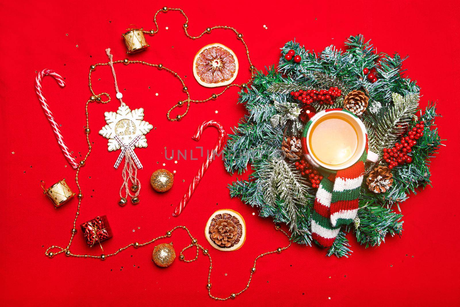 Christmas layout on a red background . New year's layout on a red background . Holiday. Holiday card. The view from the top. Christmas wreath. Fir-tree branches. Red background