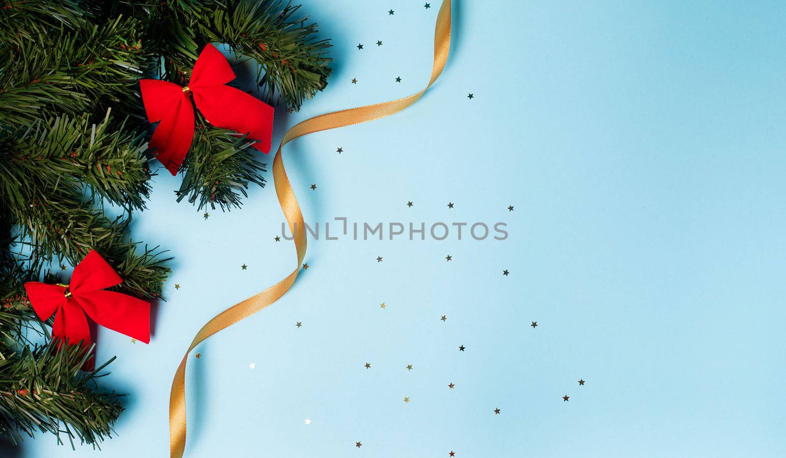 Christmas layout on a blue background . holiday greeting card copy space. spruce branches.