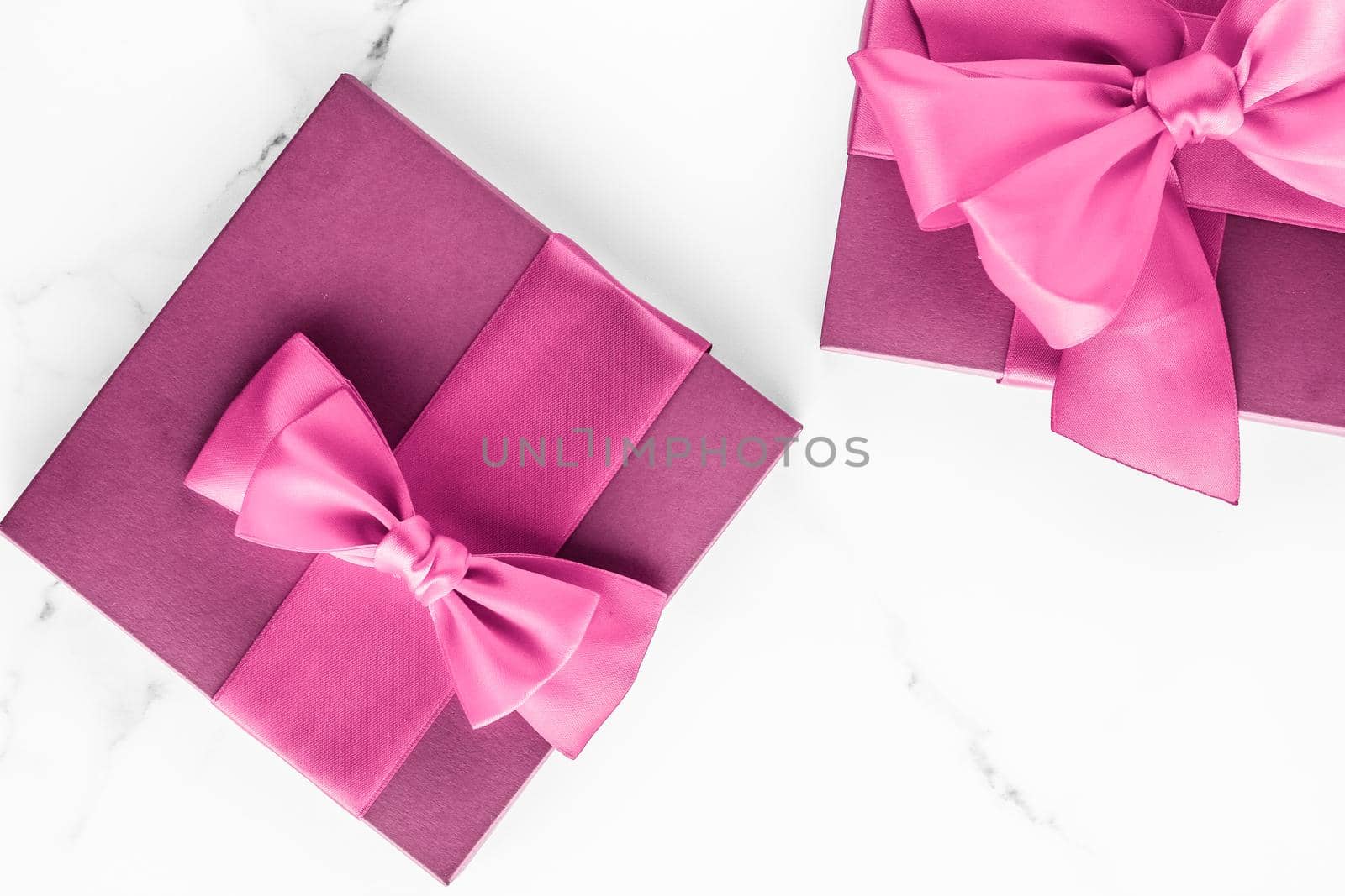 Birthday, wedding and girly branding concept - Pink gift box with silk bow on marble background, girl baby shower present and glamour fashion gift for luxury beauty brand, holiday flatlay art design