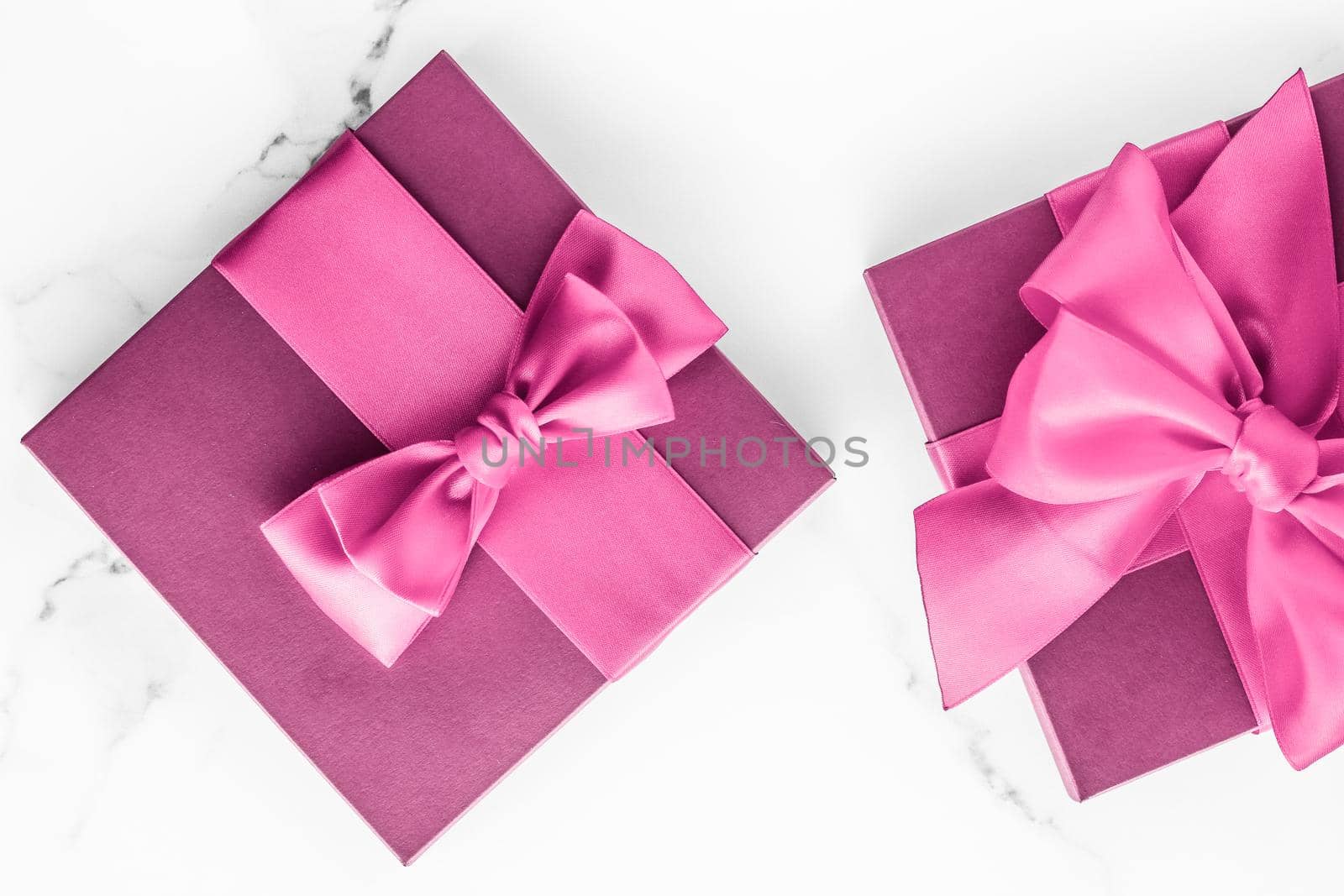 Birthday, wedding and girly branding concept - Pink gift box with silk bow on marble background, girl baby shower present and glamour fashion gift for luxury beauty brand, holiday flatlay art design