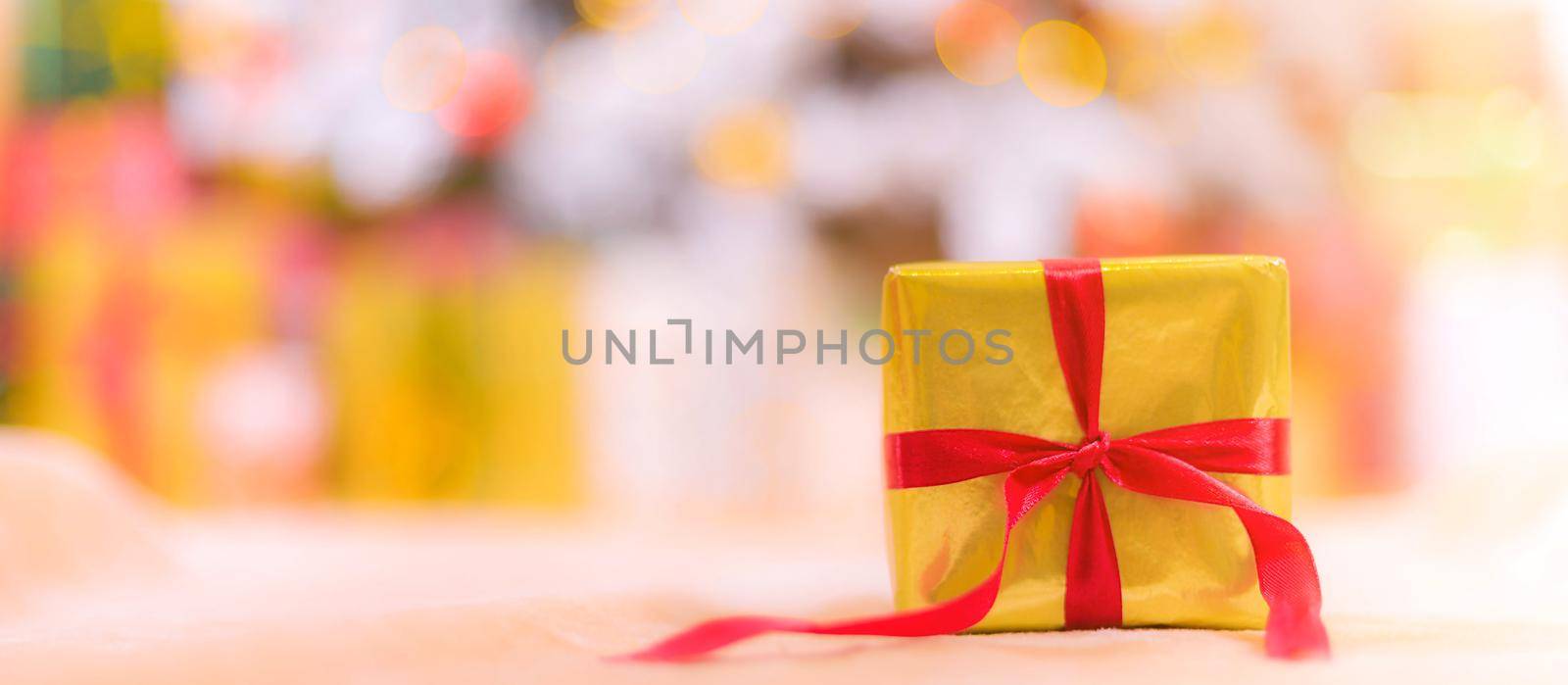 Golden gift banner . Copy space new year . Christmas. A gift for the holiday. The blur of the background. Article about the selection of gifts