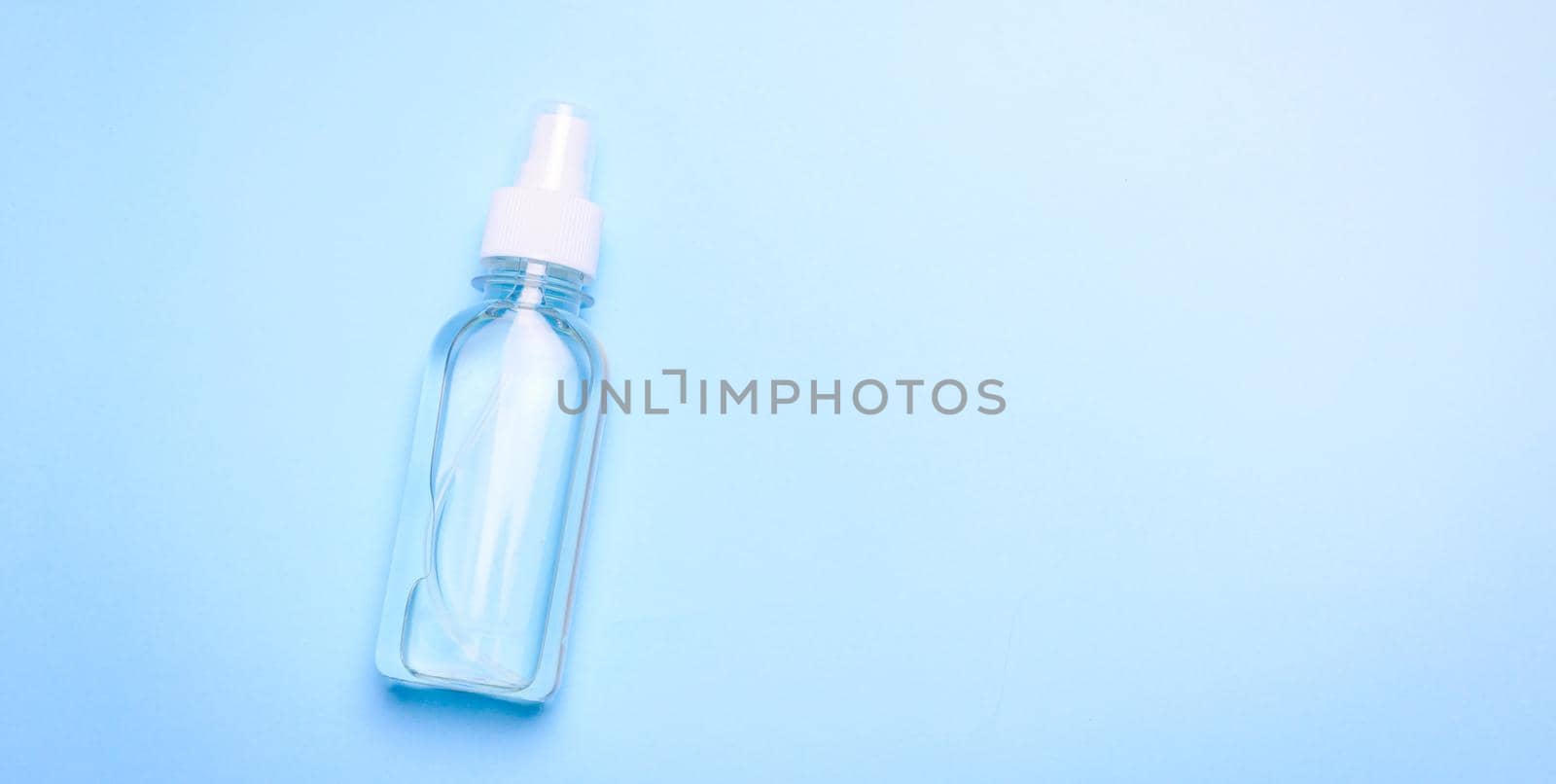 Antiseptic on a blue background . hand treatment. protection from the virus. antibacterial. a jar of antiseptic. coronavirus. pandemic. prevention. Copy space