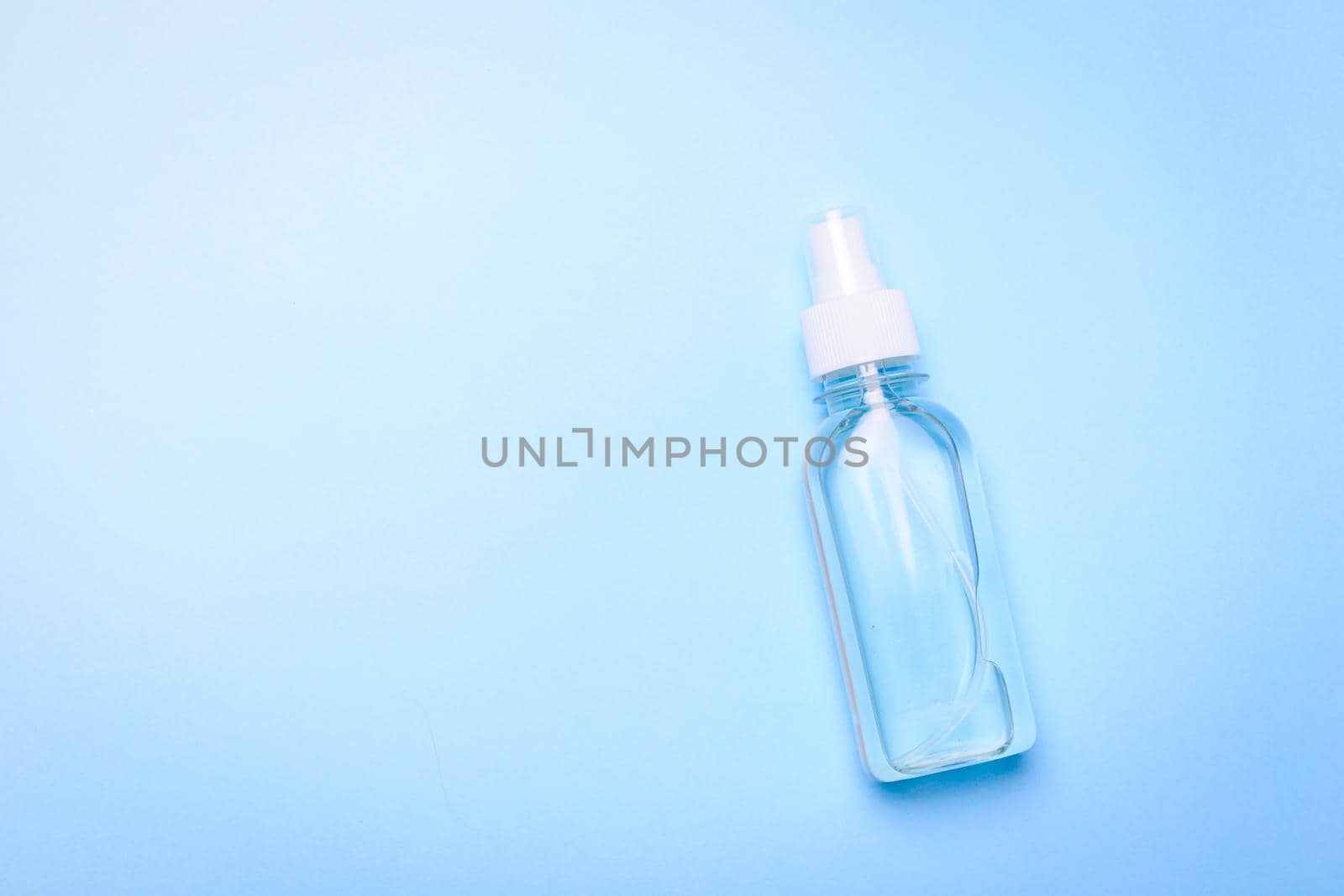 Antiseptic on a blue background . hand treatment. protection from the virus. antibacterial. a jar of antiseptic. coronavirus. pandemic. prevention. Copy space