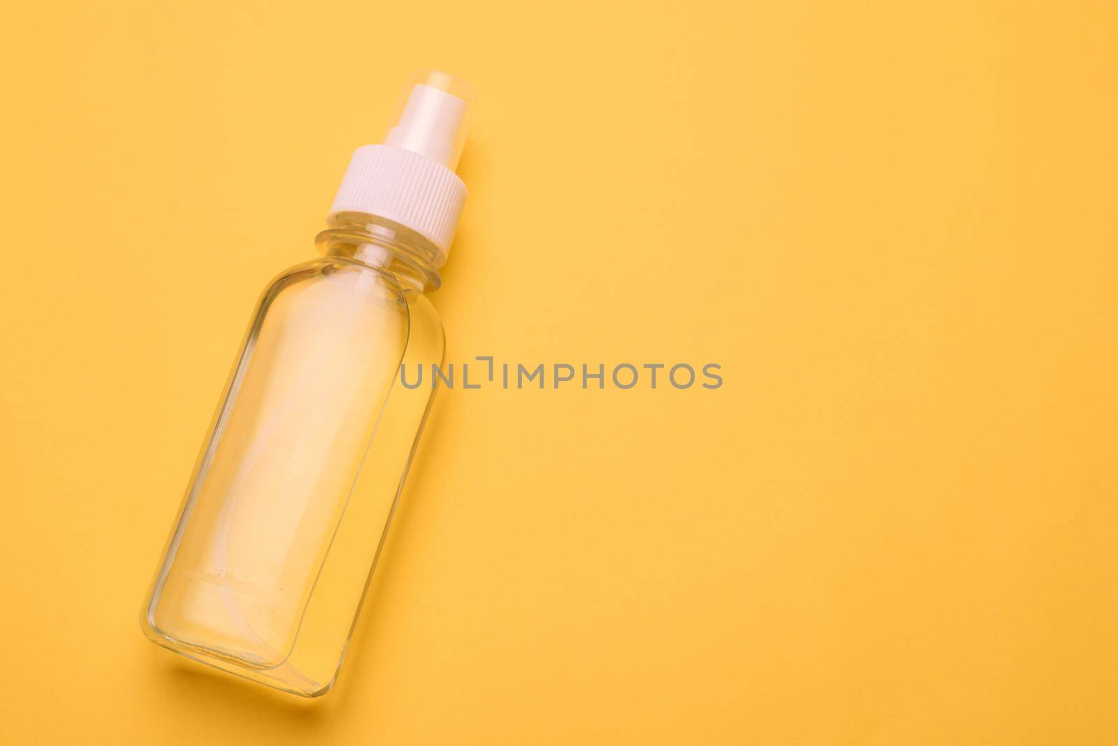 Antiseptic on a yellow background . hand treatment. protection from the virus. antibacterial. a jar of antiseptic. coronavirus. pandemic. prevention. Copy space