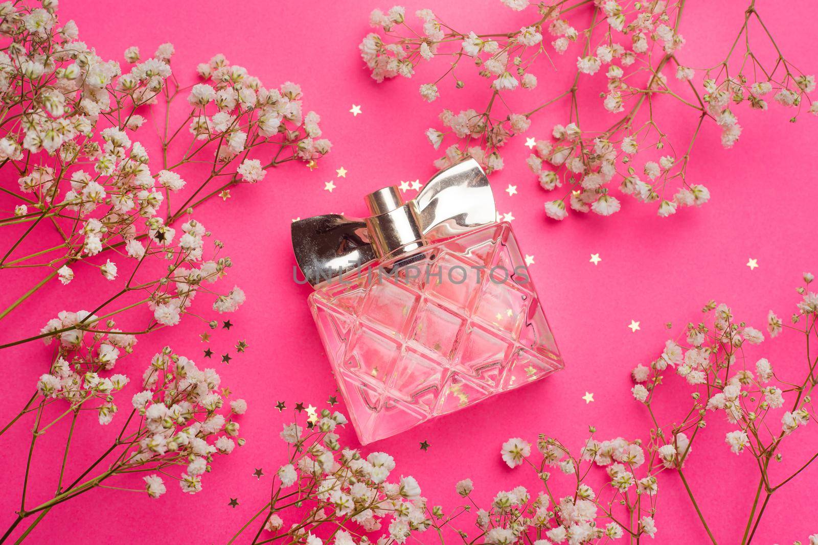 The perfume and flowers layout . Aromatherapy. Women's perfume. White flowers. Article about the choice of fragrance. Article about women's perfume. A bottle of perfume. Fresh flowers.