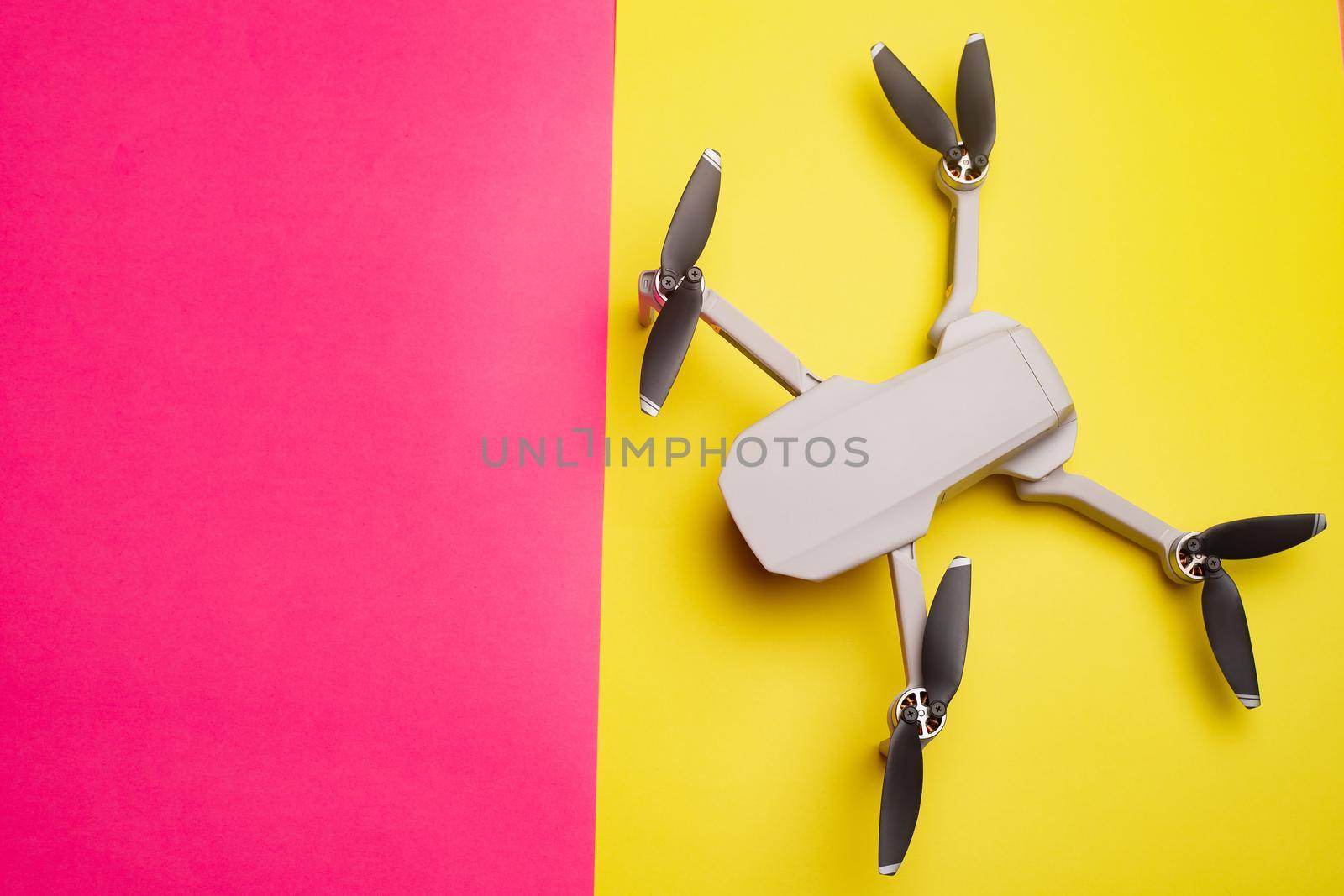 Quadrocopter on the background . Drone. Drone on a pink background. An article about modern technologies. Modern cameras. Shooting from the air. Article about choosing a quadrocopter. Characteristics and usage of the drone. Copy space