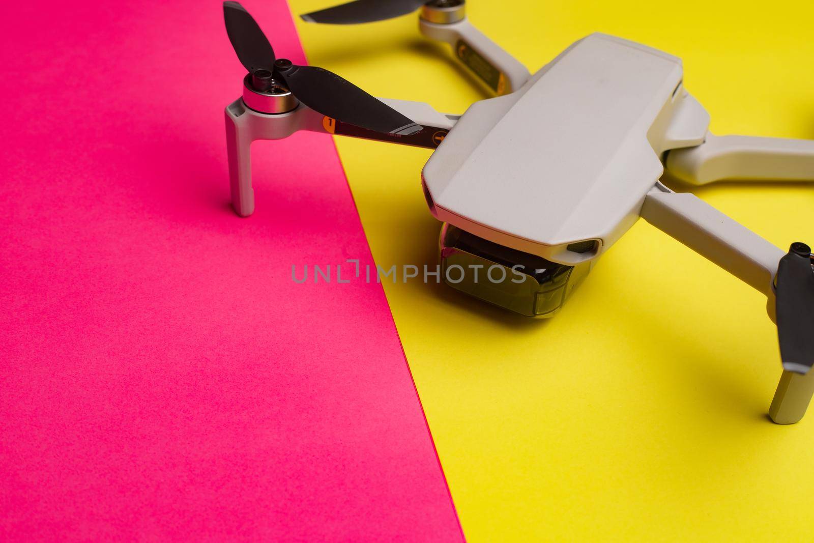 Quadrocopter on the background . Drone. Drone on a pink background. An article about modern technologies. Modern cameras. Shooting from the air. Article about choosing a quadrocopter. Characteristics and usage of the drone. Copy space