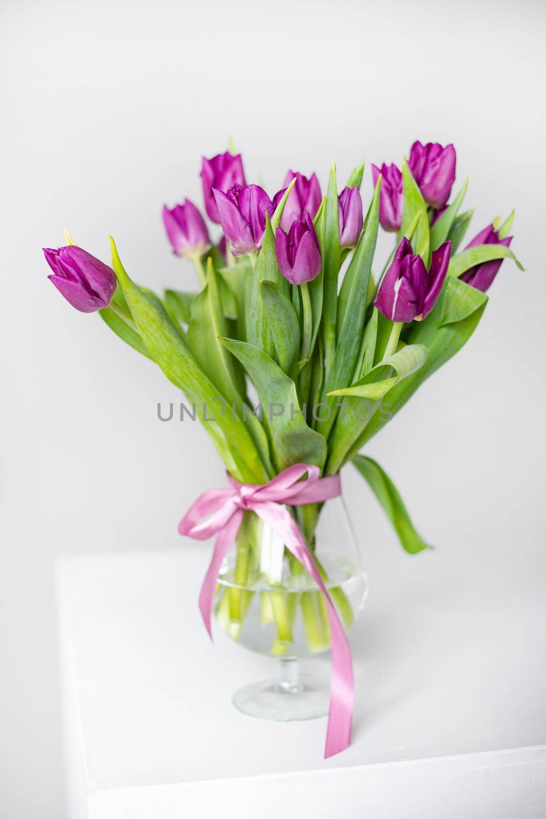 A bouquet of lilac tulips in a vase . Bouquet of tulips. Flowers in a vase. A greeting card. Valentine's day. March 8. Mother's Day. Copy space by alenka2194