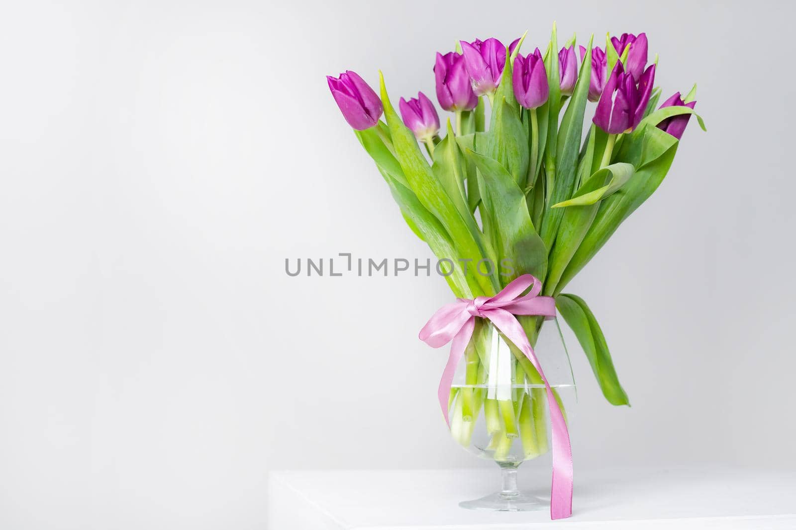 A bouquet of lilac tulips in a vase . Bouquet of tulips. Flowers in a vase. A greeting card. Delicate flowers. Valentine's day. March 8. Mother's Day. Copy space