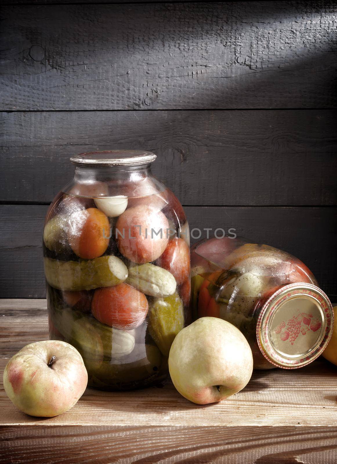 Canned vegetables in glass jars on a shelf in the basement by georgina198