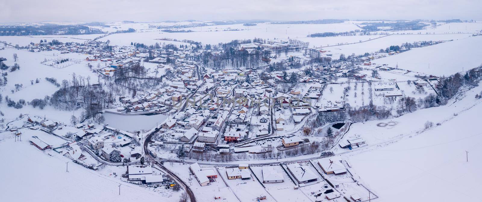 Aerial view of village with residential buildings in winter. by artush