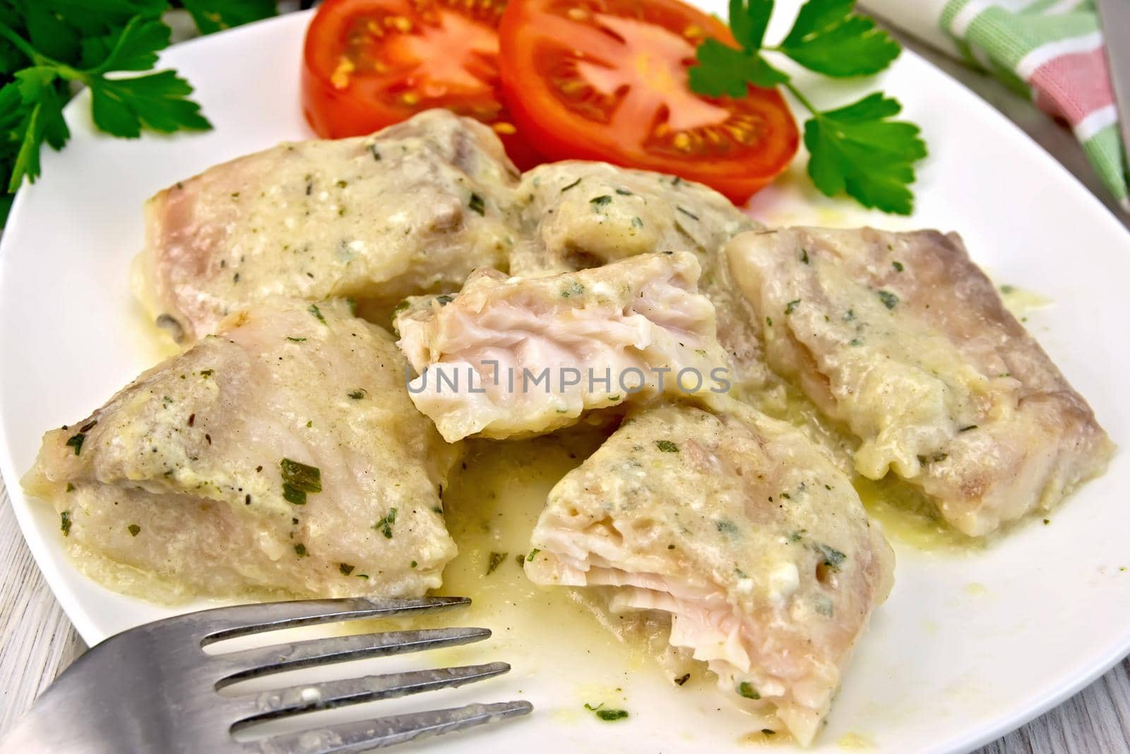 Fish stew with cream sauce in plate on board by rezkrr