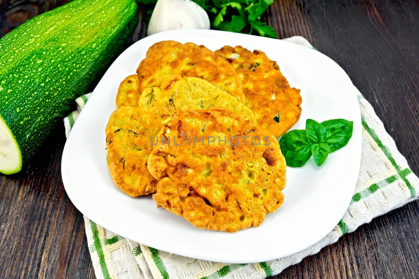 Flapjack chickpeas with zucchini in plate on dark board by rezkrr