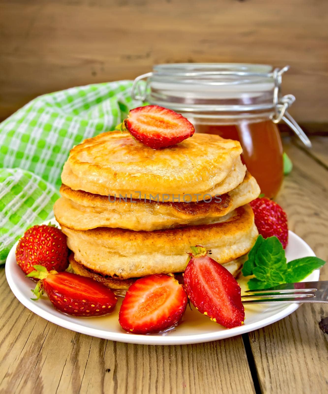 Flapjacks with strawberries and honey on board by rezkrr