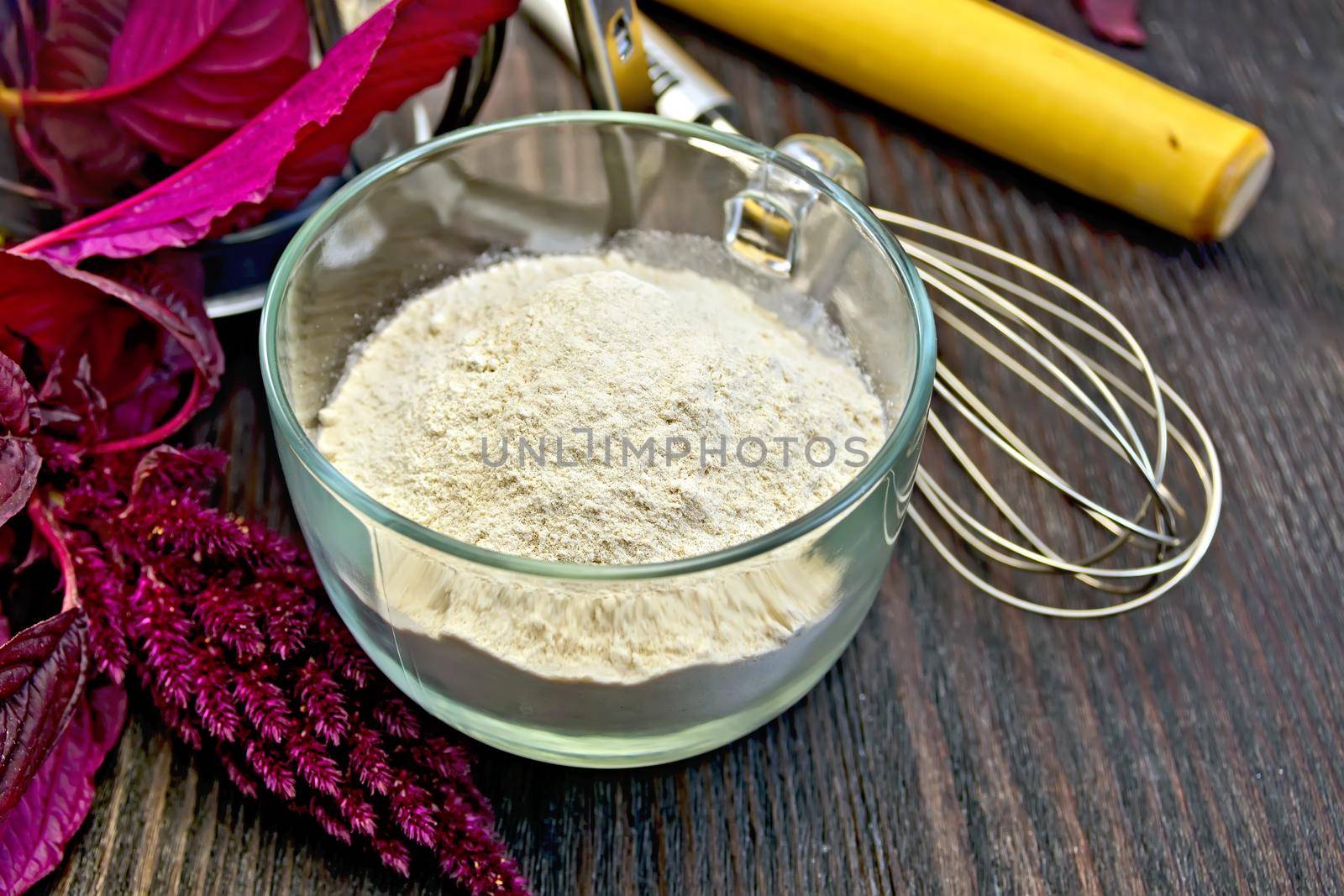 Flour amaranth in cup with rolling pin on board by rezkrr