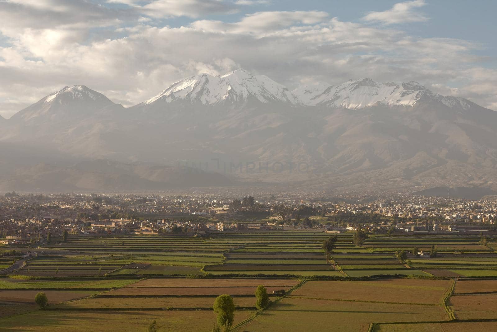 City of Arequipa, Peru with its iconic fields and volcano Chachani in the background