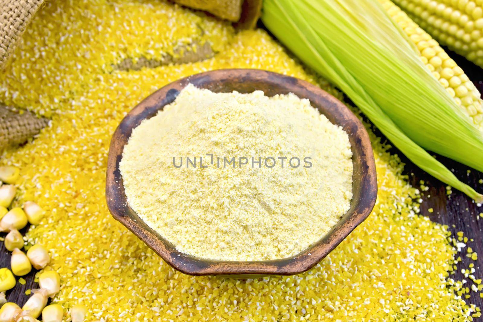 Flour corn in bowl with grains on board by rezkrr