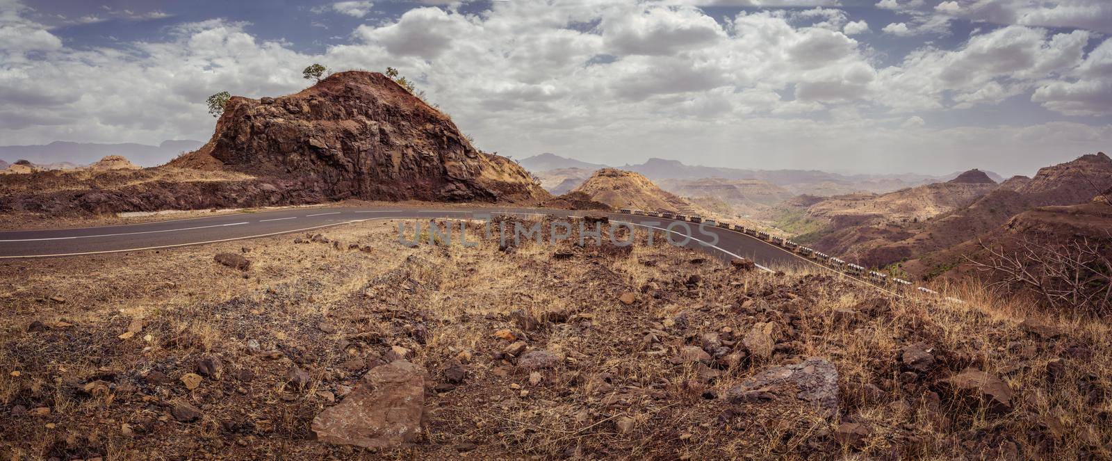 Stony winding road in Semien or Simien Mountains National Park landscape in Northern Ethiopia. Africa wilderness, Sunny morning with blue sky