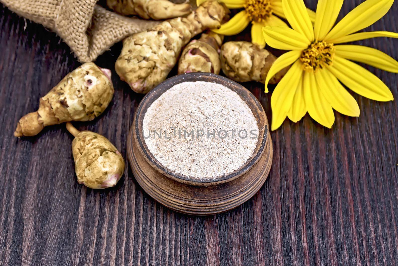 Flour of Jerusalem artichoke in clay bowl on board by rezkrr
