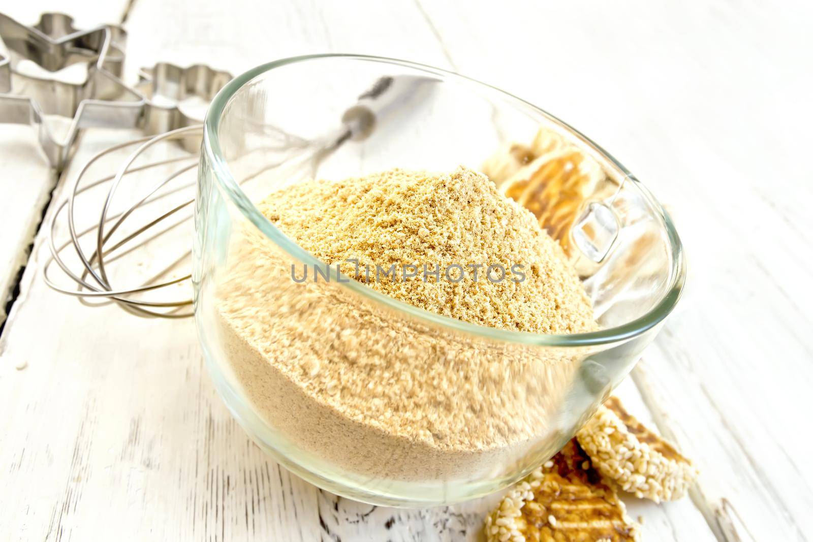 Flour sesame in cup with cookies on board by rezkrr