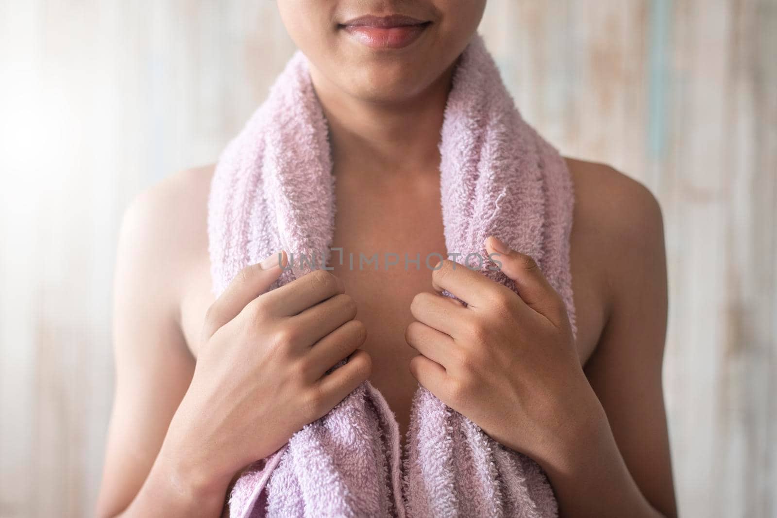 One teenage male standing while holding towel on his shoulder. Concept of hygiene and lifestyle