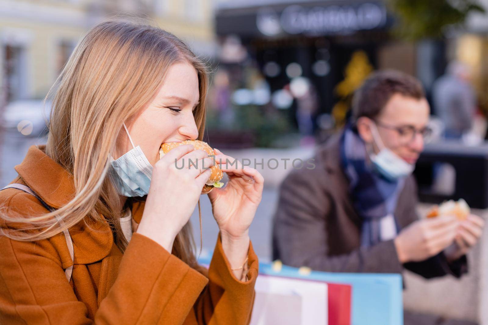 Couple eating fast food outdoors during shutdown by Kzenon