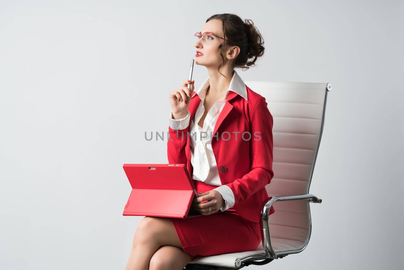 Businesswoman with laptop computer thinking by Kzenon