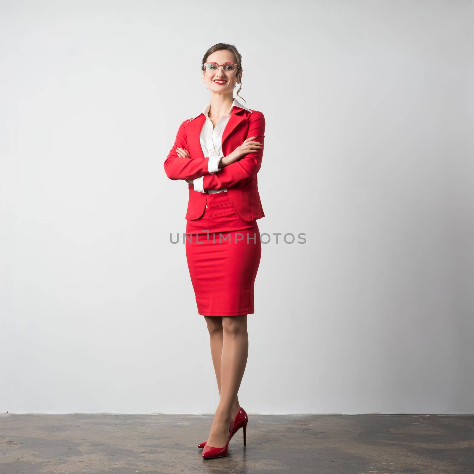 Proud businesswoman standing arms folded looking at the camera