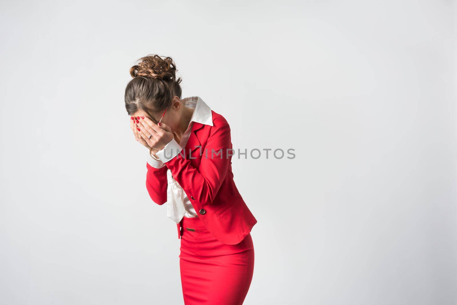 Overwhelmed businesswoman crying holding arms in front of her face