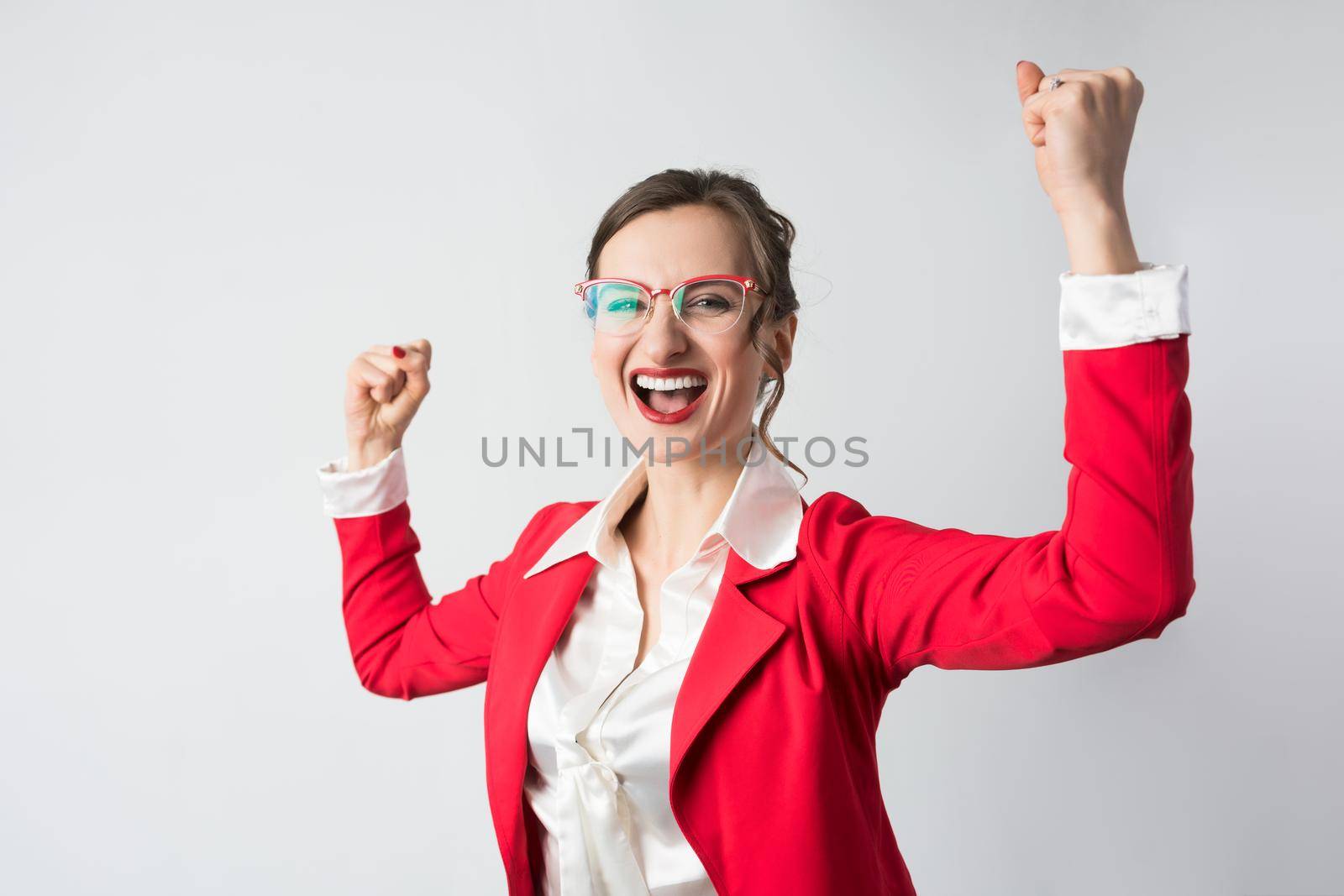 Businesswoman celebrating a success standing in victorious pose