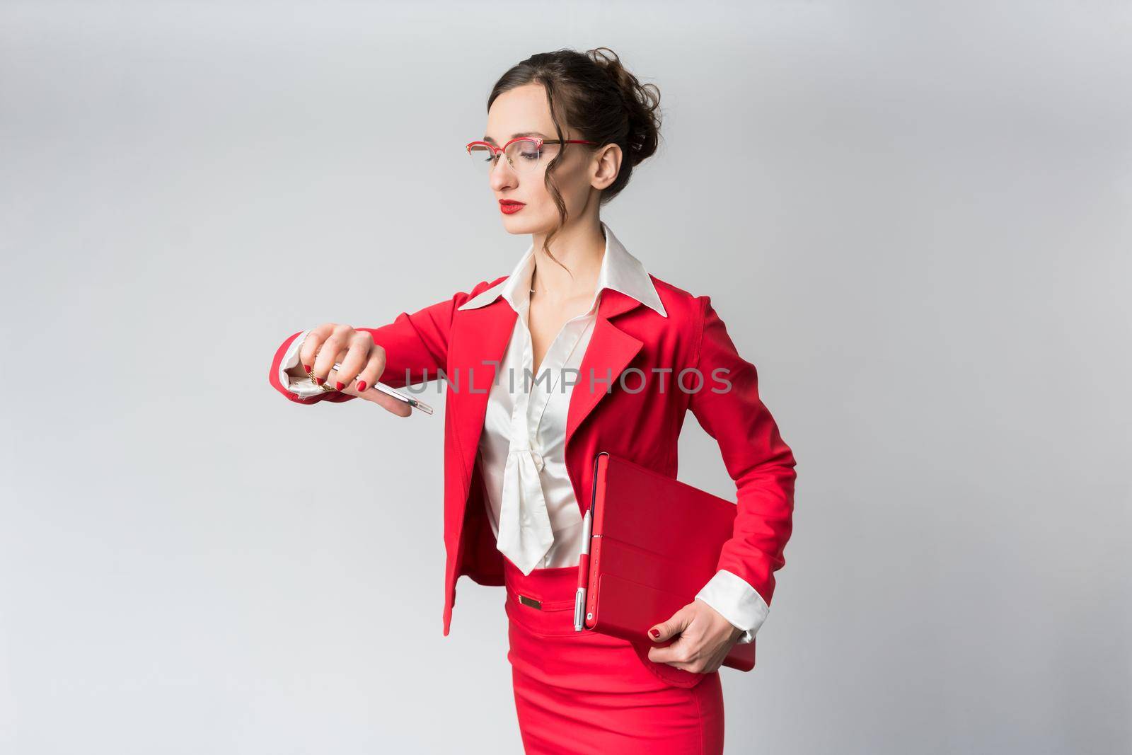 Businesswoman being late to her meeting checking the time on wristwatch