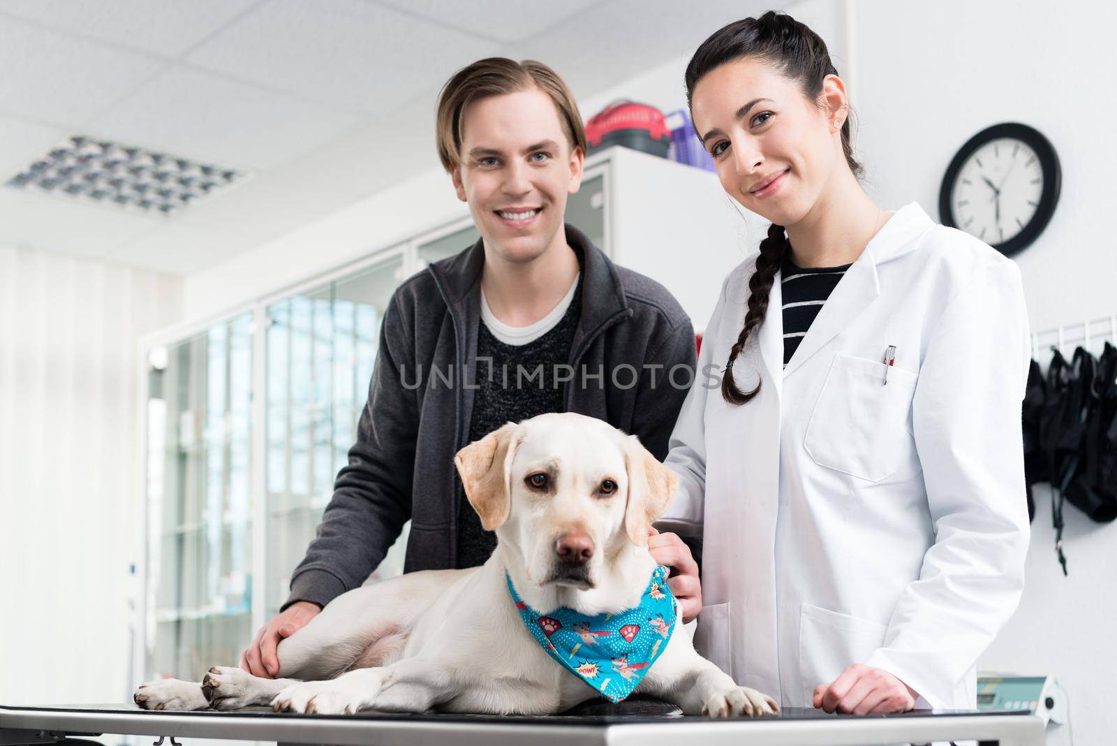 Portrait of a smiling veterinarian with dog by Kzenon