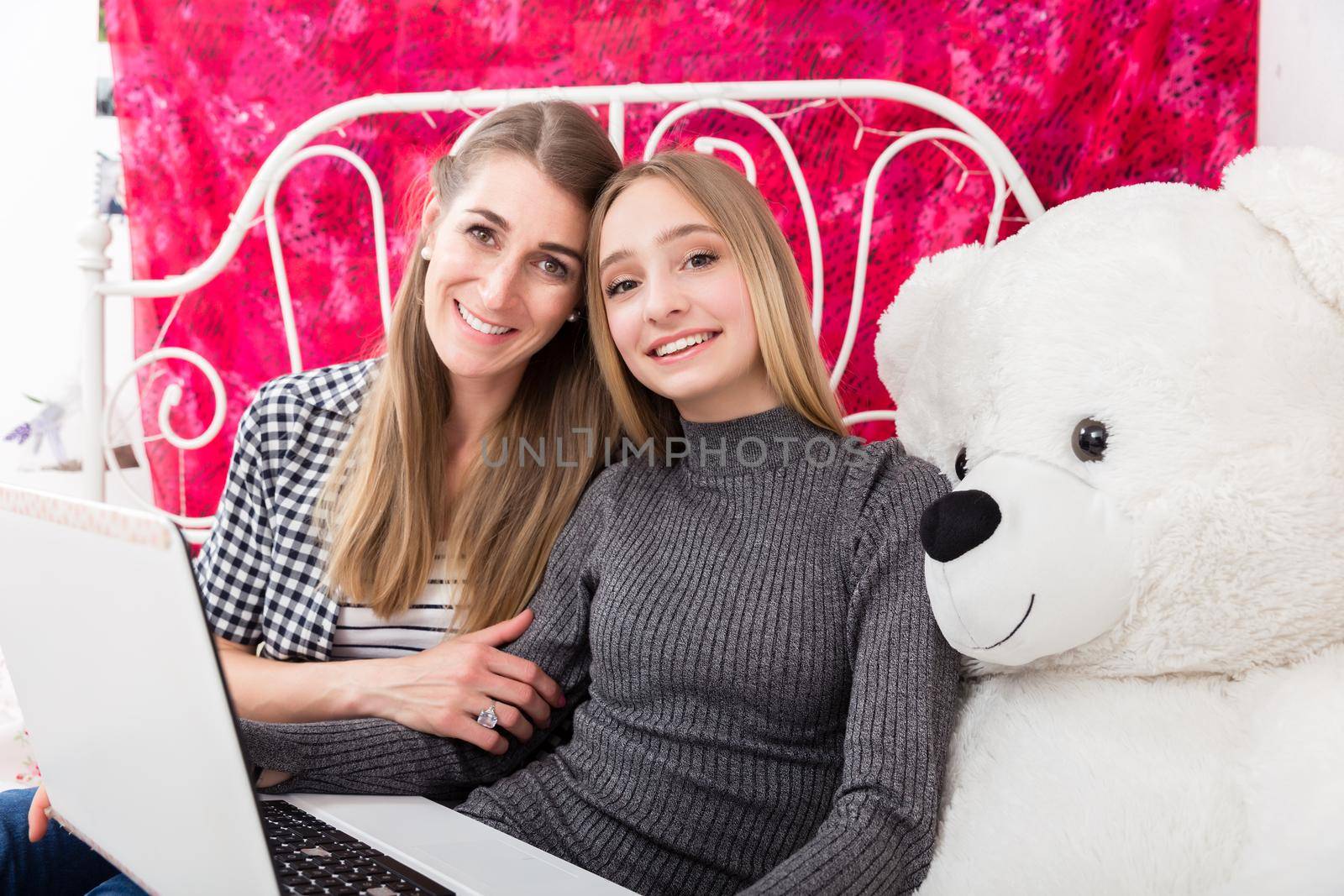 Mother and daughter having fun on the computer by Kzenon