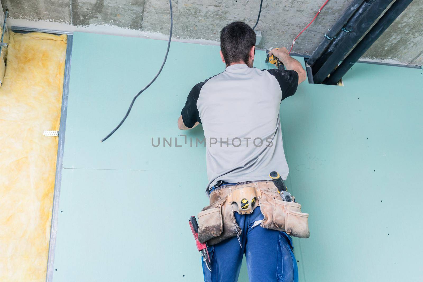 Construction worker completing the interior of a building