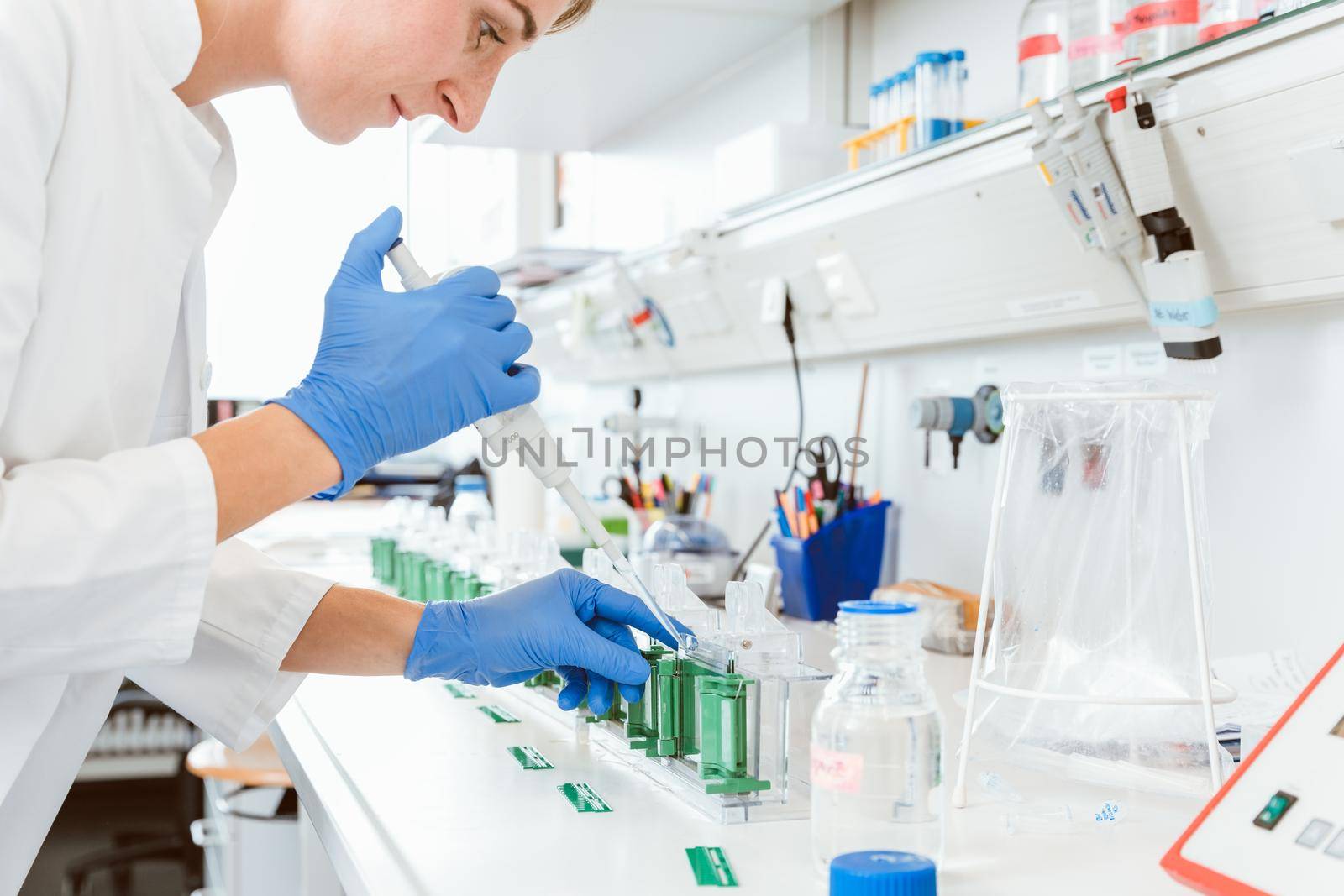 Female caucasian doctor experimenting sample using dropper