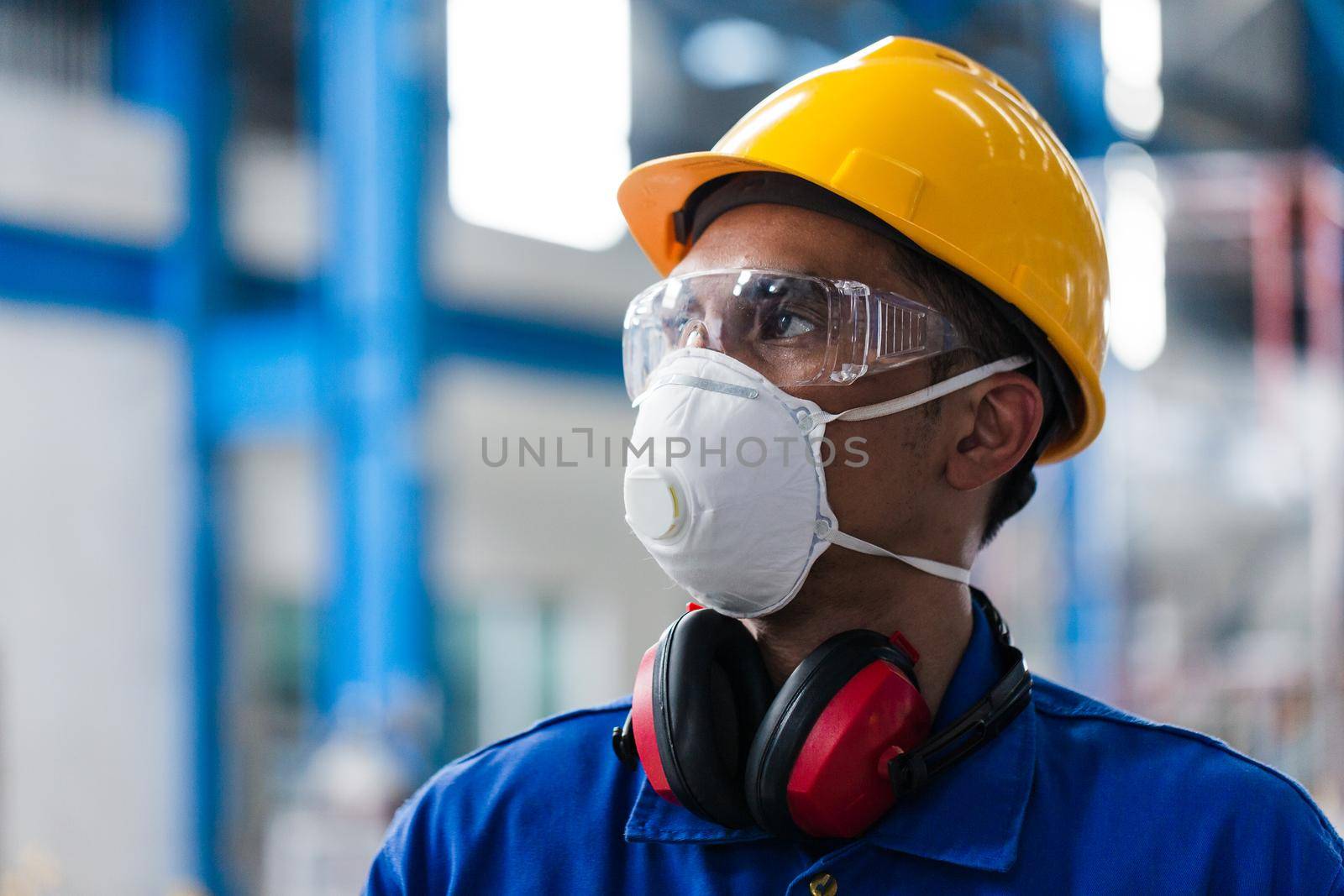 Low-angle view of a skilled Asian worker with protective mask