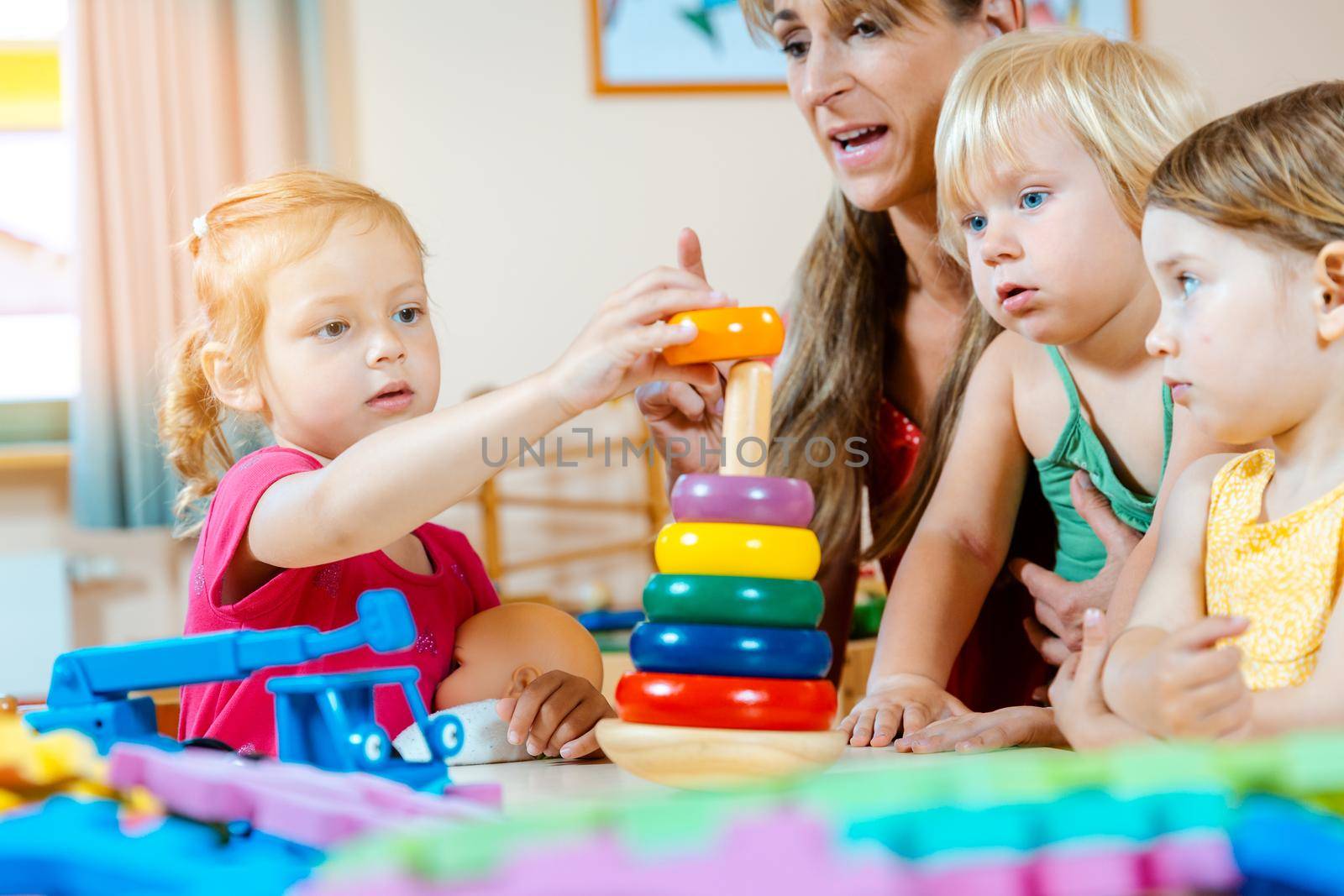 Children in nursery school learning and playing games