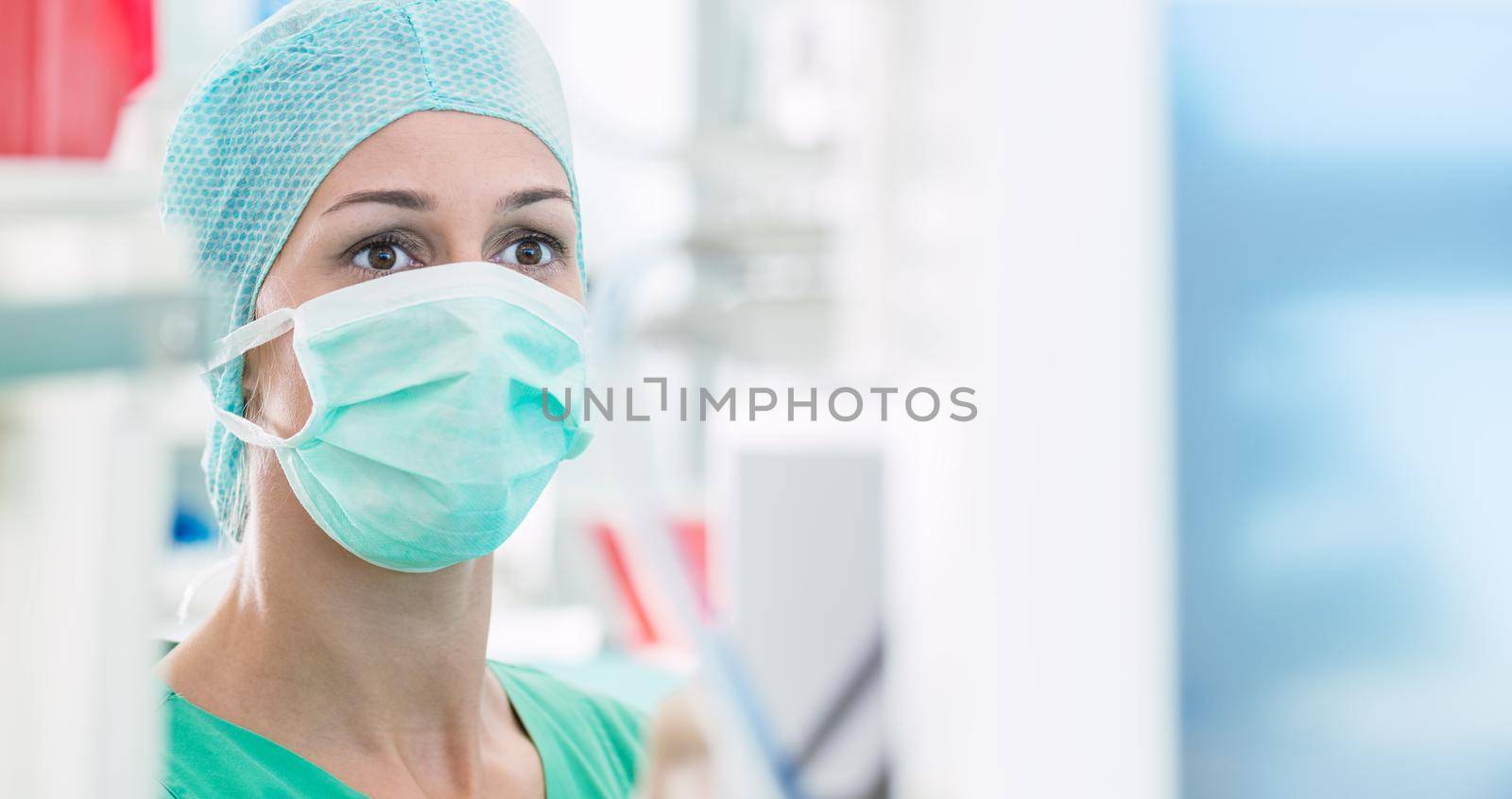 Doctor or nurse in operating room on heart monitor by Kzenon