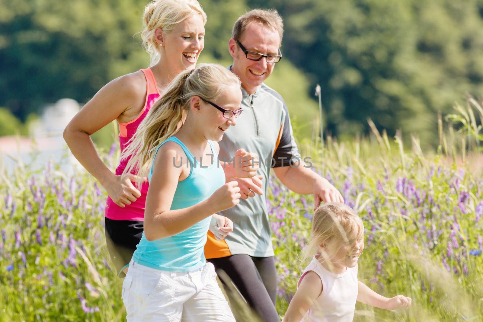 Parents with two children sport running outdoors