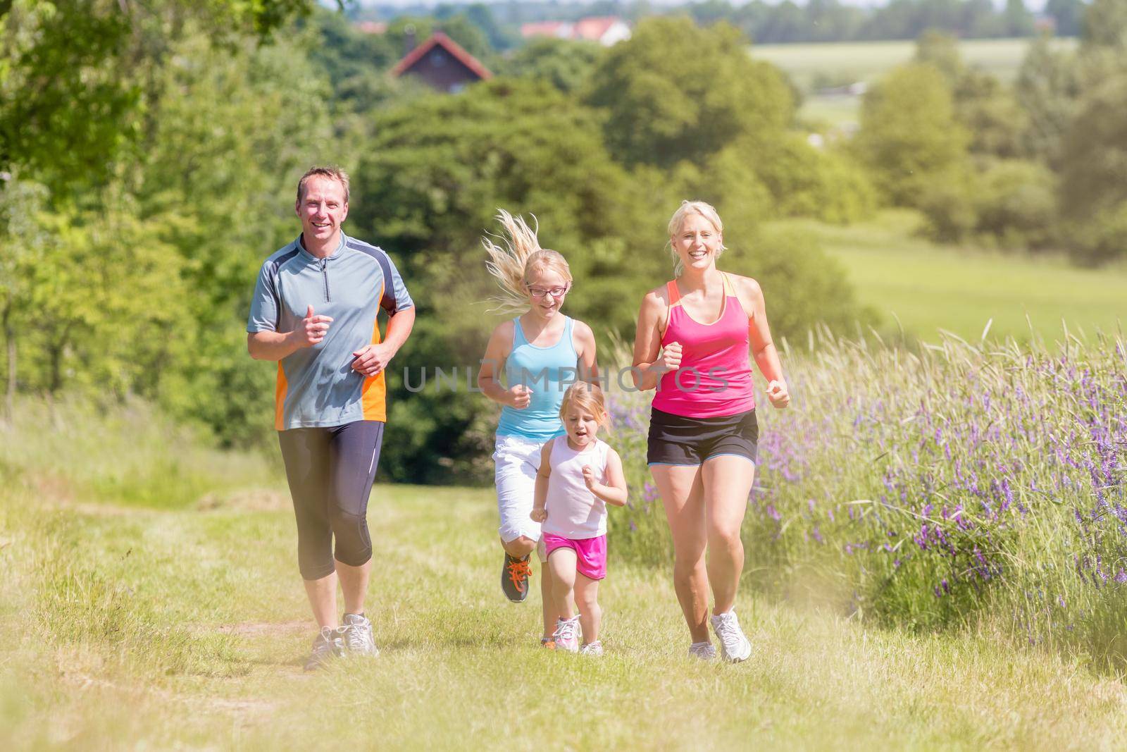 Family sport running through field by Kzenon