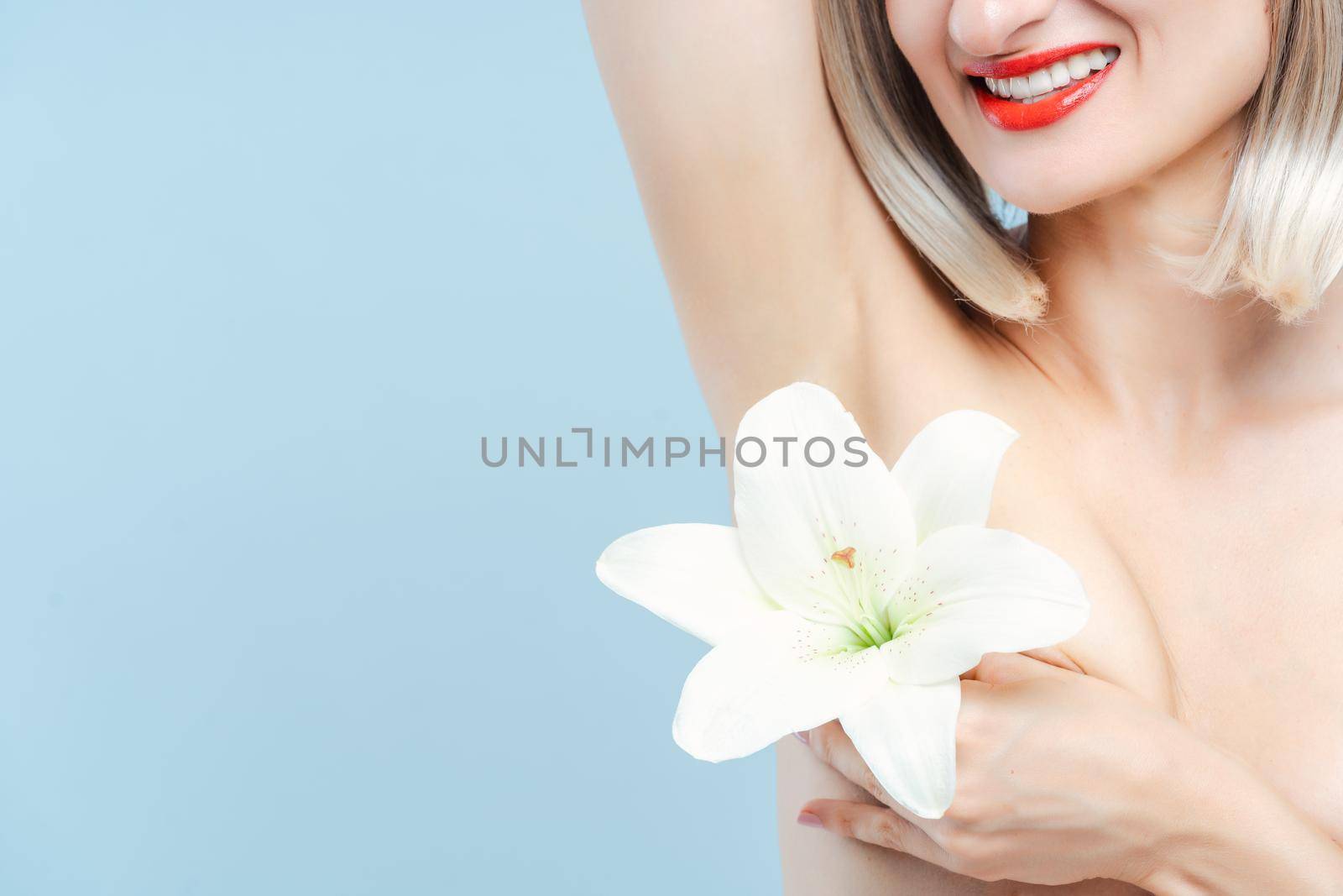 Beautiful woman having had hair removal at the armpit, isolated studio shot