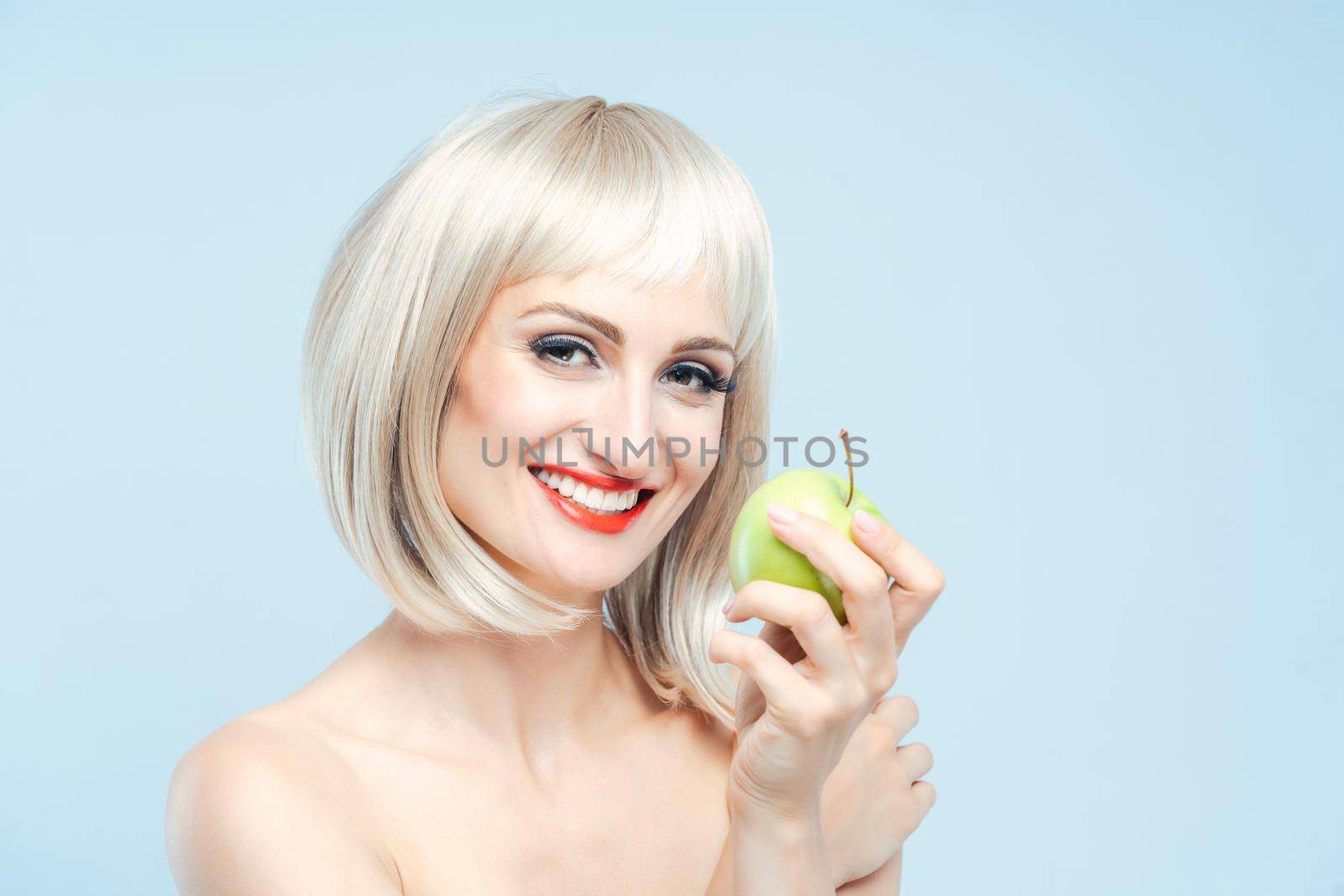 Beautiful woman eating green apple for weight loss by Kzenon