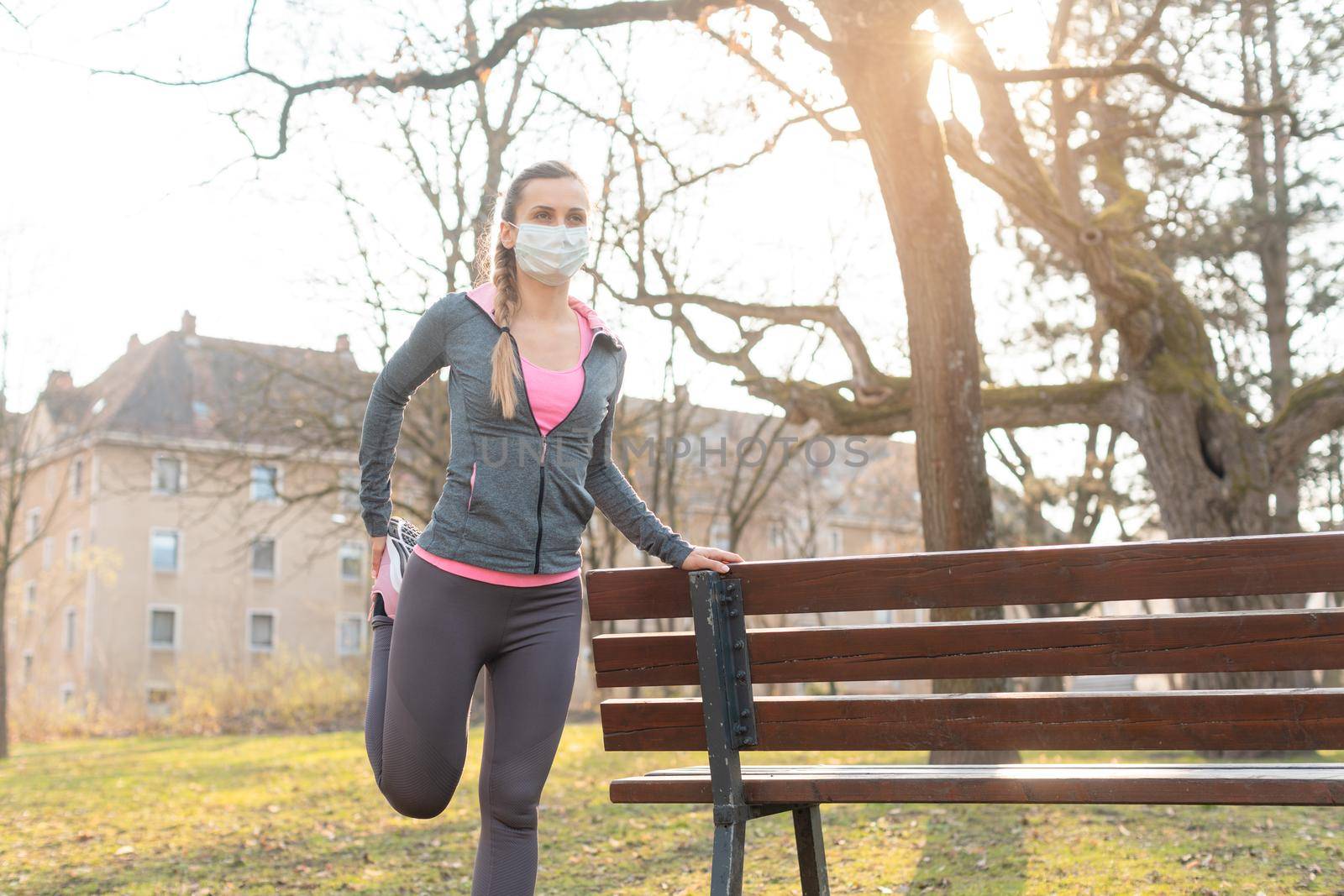 Woman during coronavirus crises exercising outdoors by Kzenon